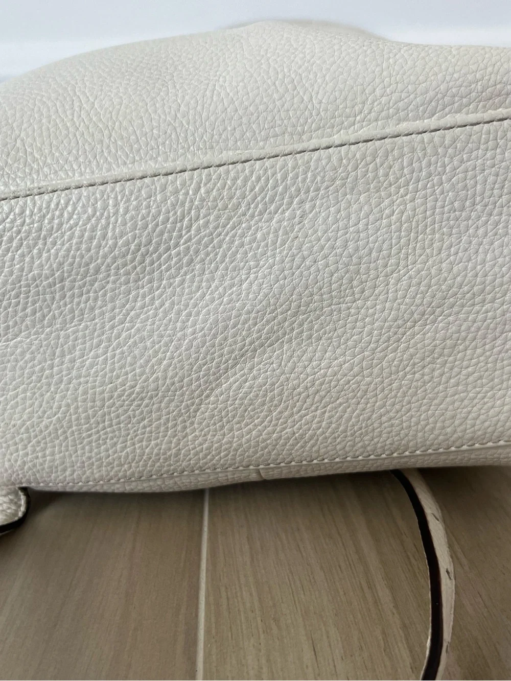Kate Spade New York creamy white leather drawstring flap backpack